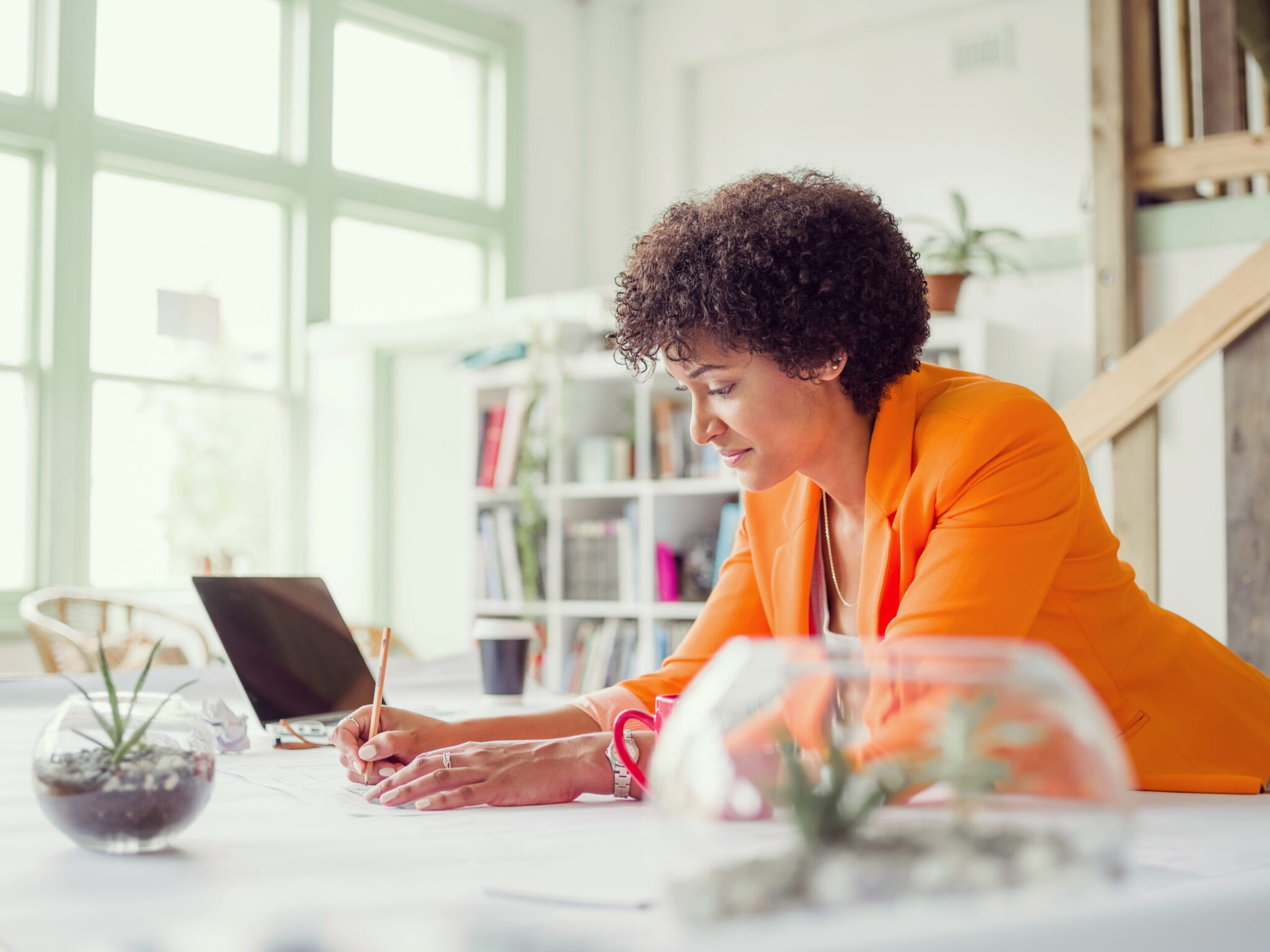 A woman working happily at desk in Council Bluffs